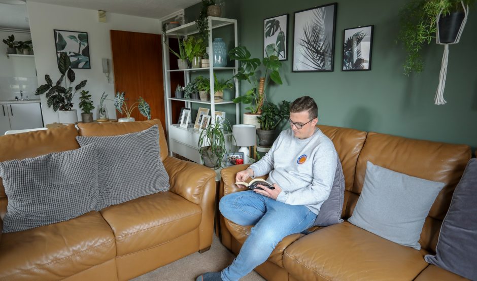 man sat reading book in home